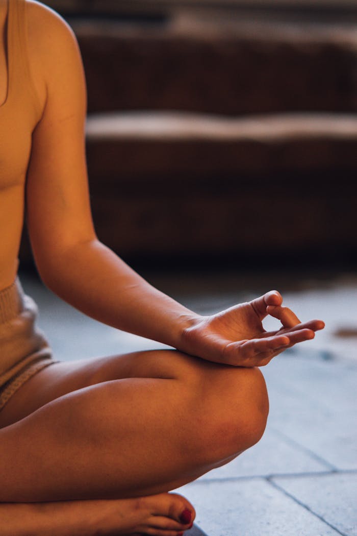 A person meditating indoors, showcasing a tranquil yoga pose with focus on relaxation and inner peace.